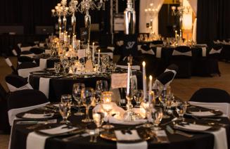 An elegantly decorated table at the President's Ball featuring a glittering centrepiece, sparkling tablewear, and beautifully folded napkins