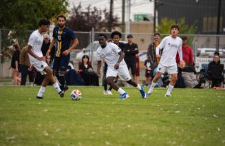 Wolves mens soccer players battling it out on the pitch in a match against Concordia Thunder