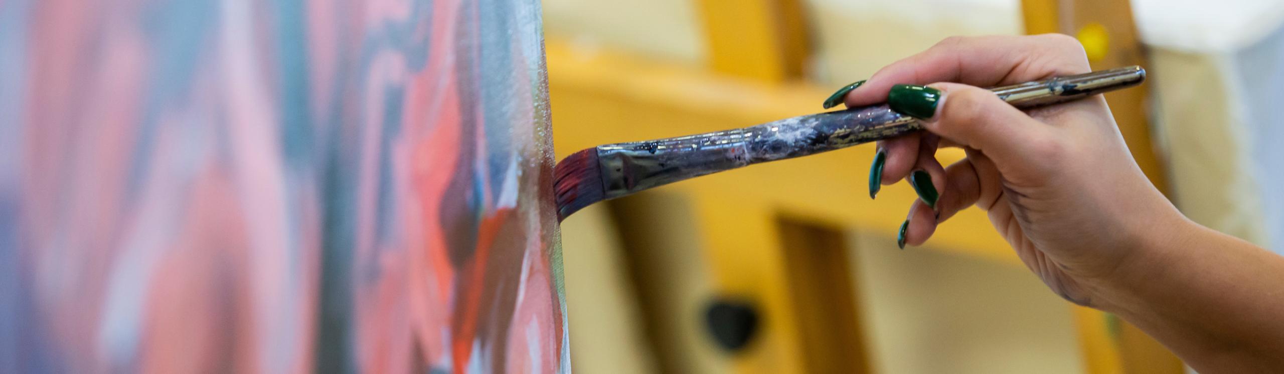 Close up of a hand painting