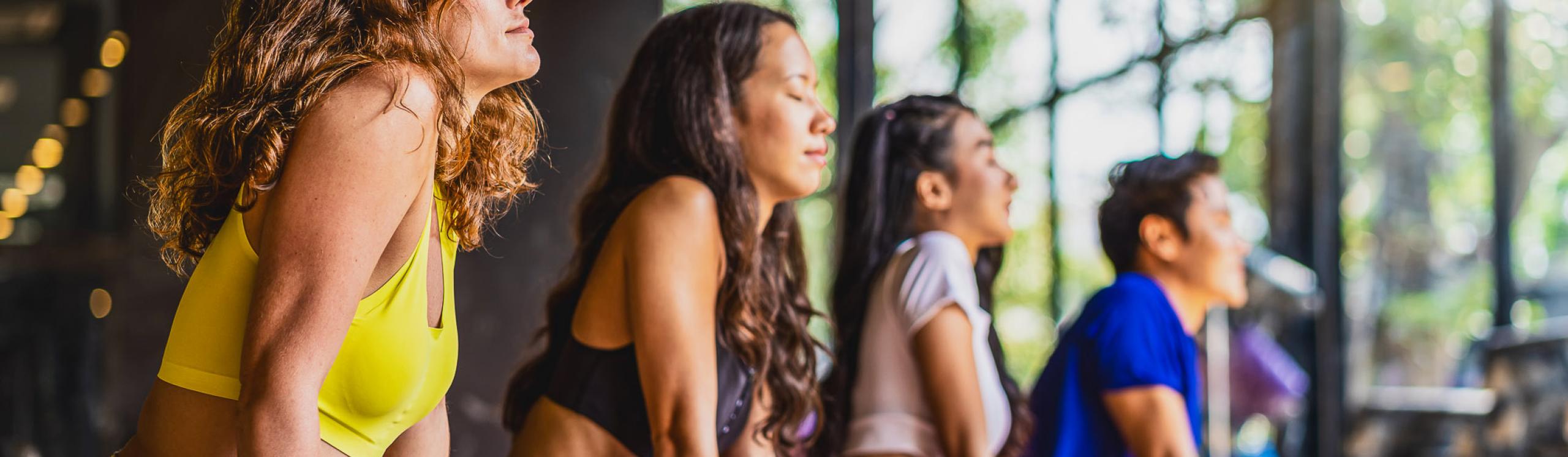 Yoga class participants holding a pose