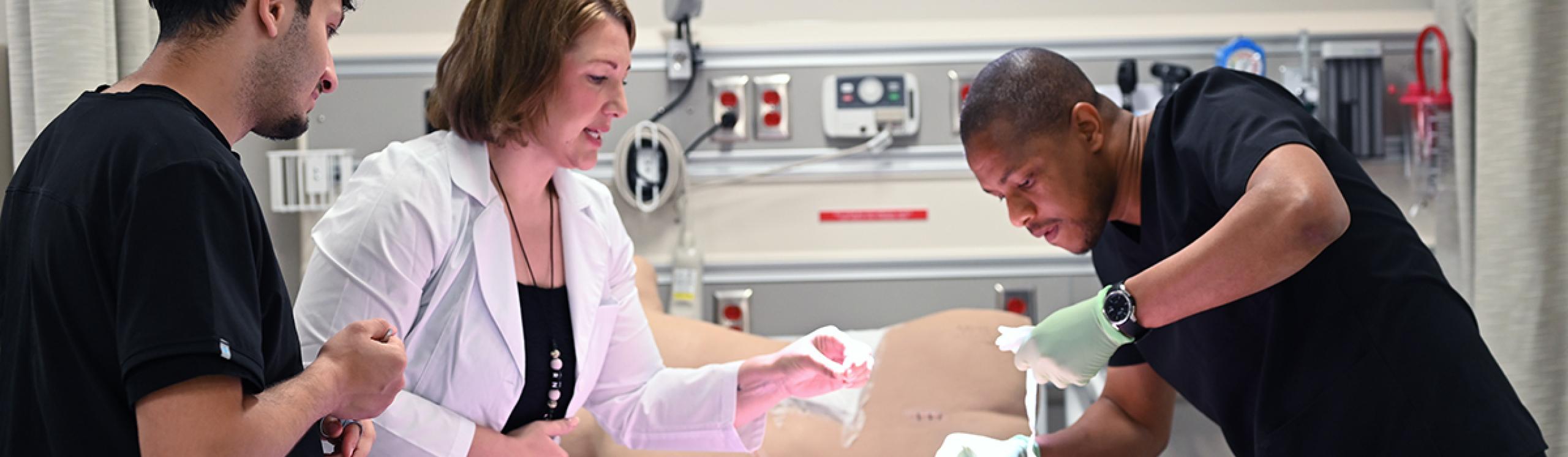 Practical nursing students receiving hands-on training in the simulation lab