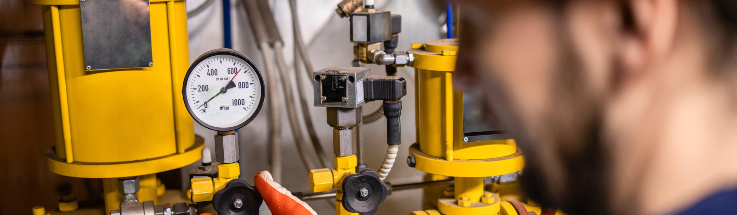 Instrumentation tech reading and adjusting a gauge