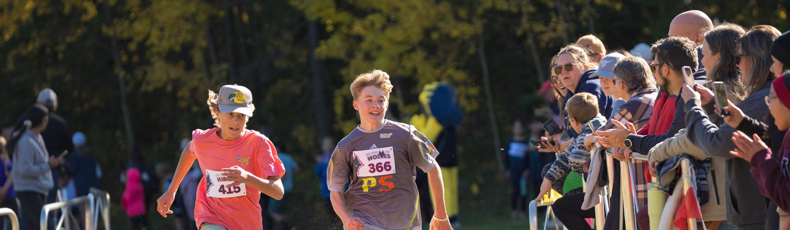 Two young athletes sprinting it out at the end of a race