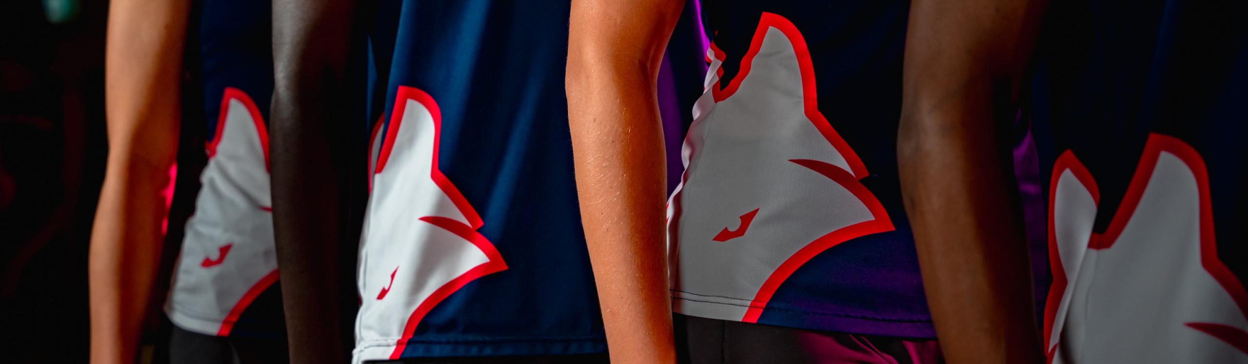 close up photo of the running vests of Wolves cross country athletes in a line