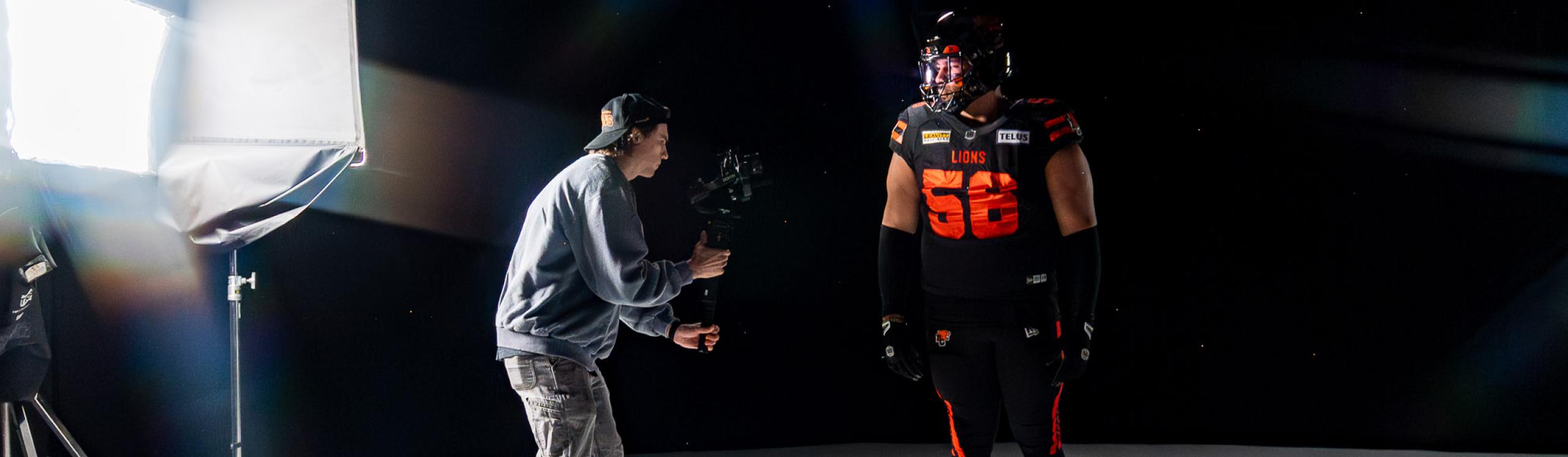 NWP alum, Liam Thomson in the studio photographing a football player