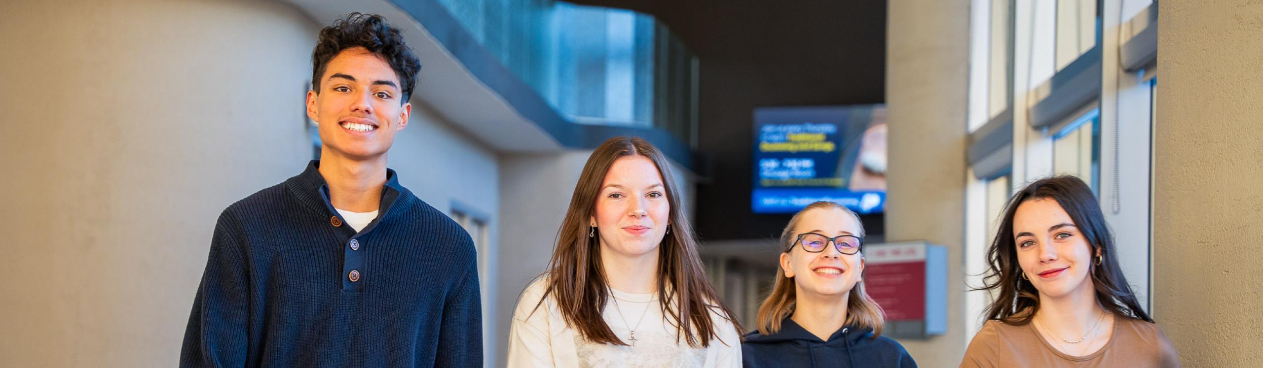 Happy NWP students walking down a hallway on the Grande Prairie campus