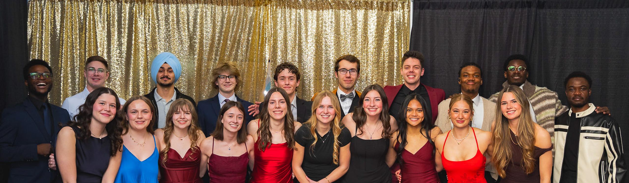 A group of smartly dressed, happy Wolves athletes posing at the 2026 Festival of Gold event 