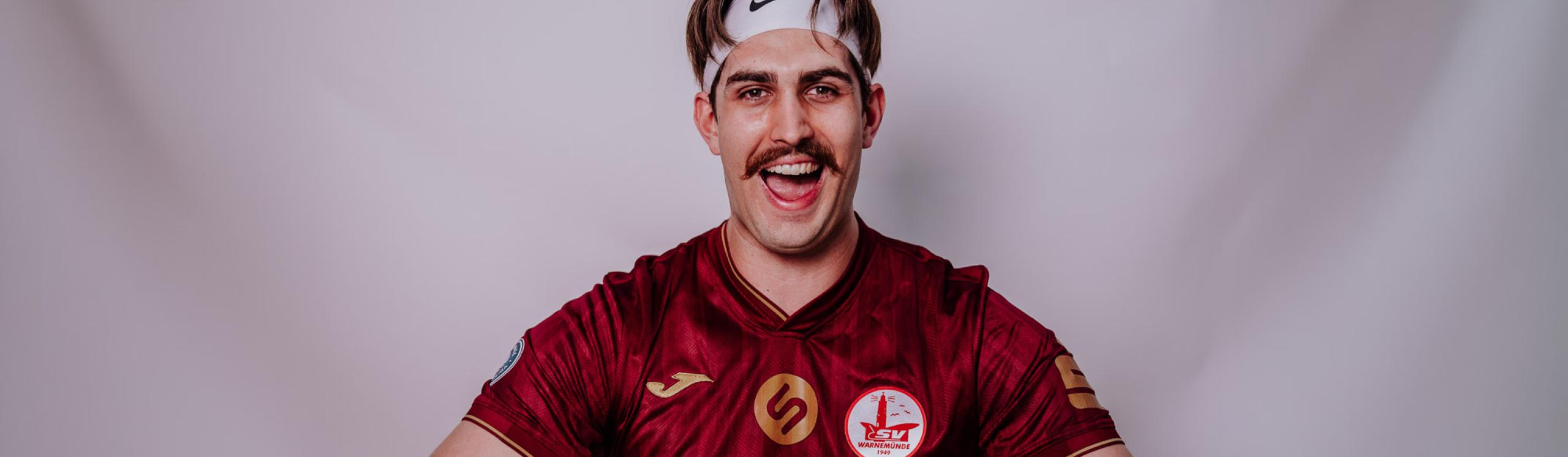 Wolves Volleyball Alumni, Tom Wheeler squeezing a volleyball flat